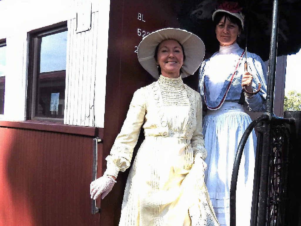 TRIP BACK IN TIME: Rachael Hodgen and Frances Pyper, from Brisbane, dress in period costume for their journey to Goondiwindi on the Downs Dasher. INSET: A crew member checks the new crank pin which split in November last year. TRIP BACK IN TIME: Rachael Hodgen and Frances Pyper, from Brisbane, dress in period costume for their journey to Goondiwindi on the Downs Dasher. INSET: A crew member checks the new crank pin which split in November last year.
